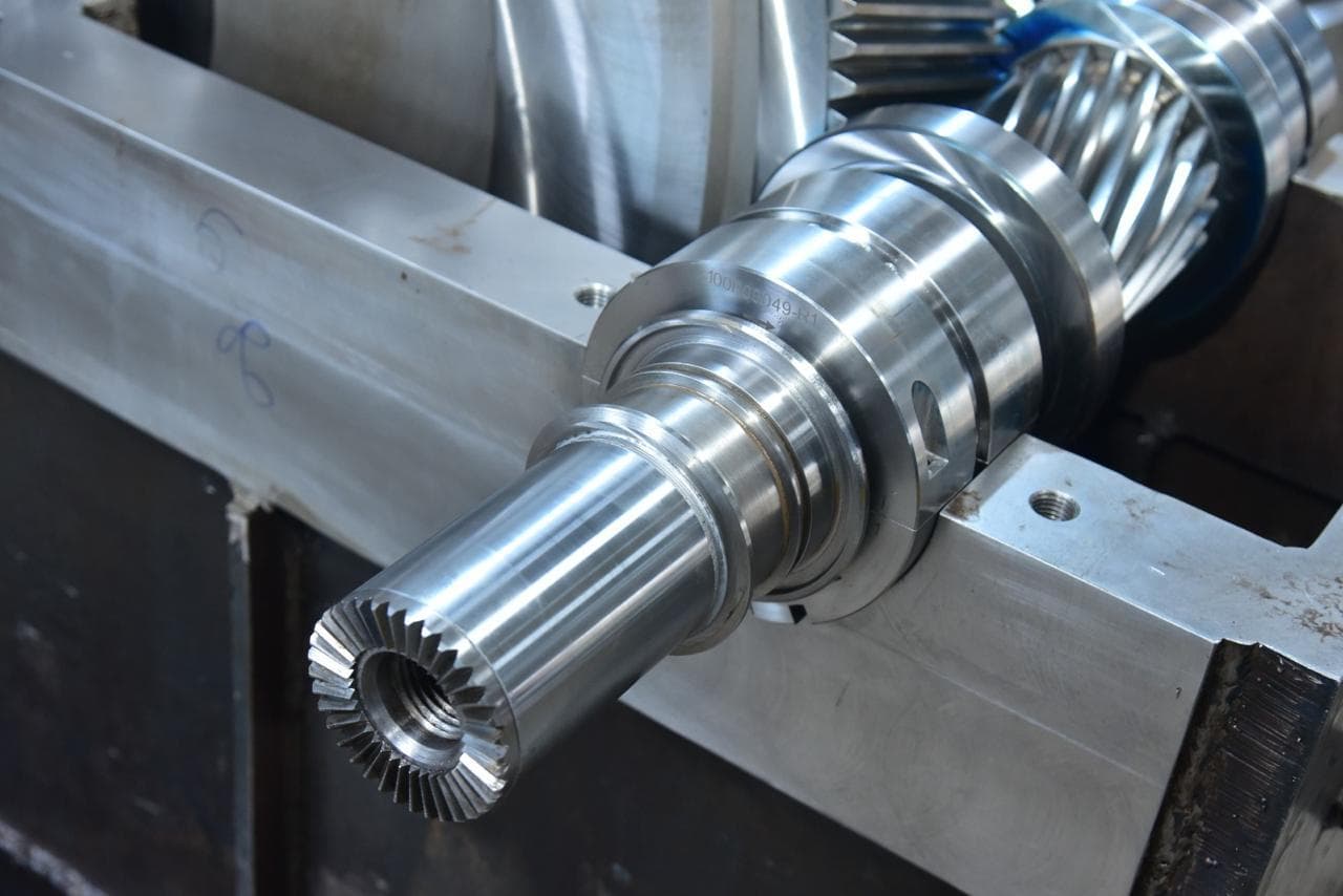 Finished pinion shaft, bearing journals and splined coupling end machined and ground