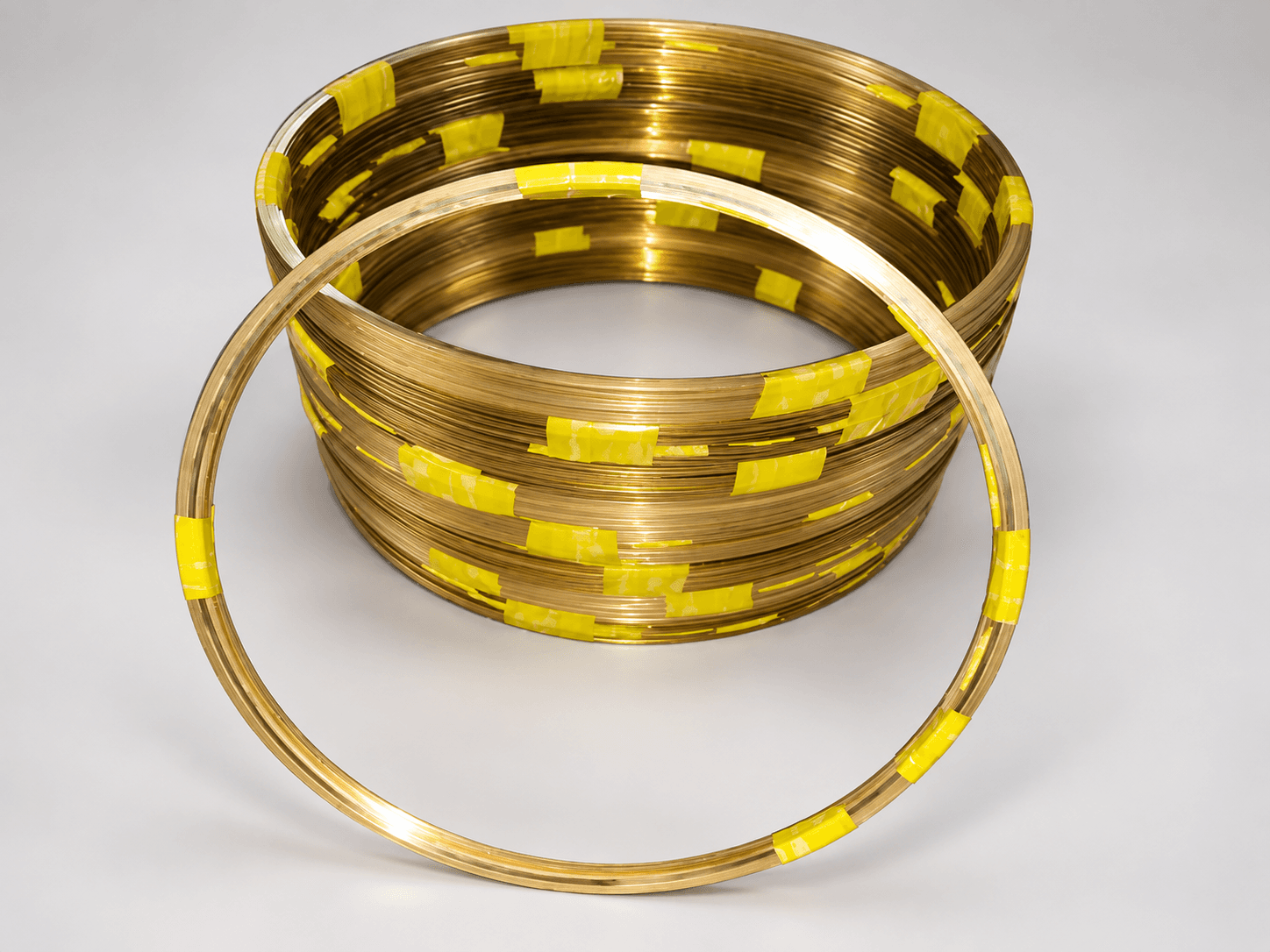 Studio photograph of continuous-coil brass sealing strips