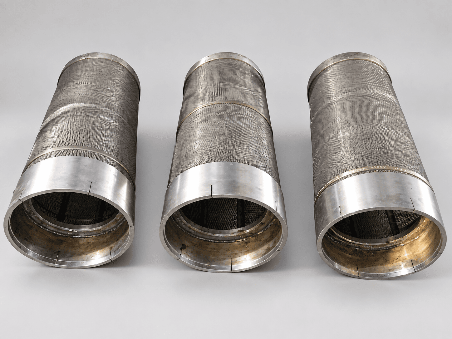 Studio photograph of three evenly spaced hot reheat steam strainers